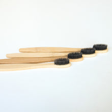Load image into Gallery viewer, Biodegradable Charcoal Infused Bamboo Toothbrushes (single or set of 4)