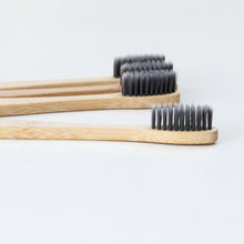 Load image into Gallery viewer, Biodegradable Charcoal Infused Bamboo Toothbrushes (single or set of 4)